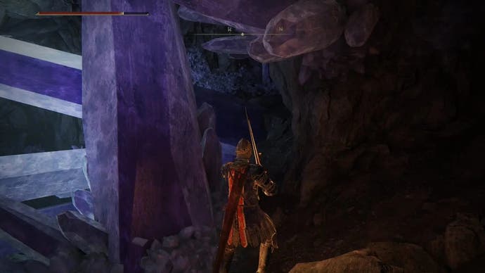 A warrior finds a corpse next to a large crystal in Elden Ring.